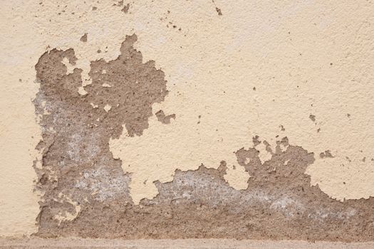 Old wall with cracked plaster showing rough textures, ideal for backgrounds.